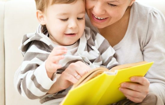 16382643 - mother is reading book for her son, indoor shoot
